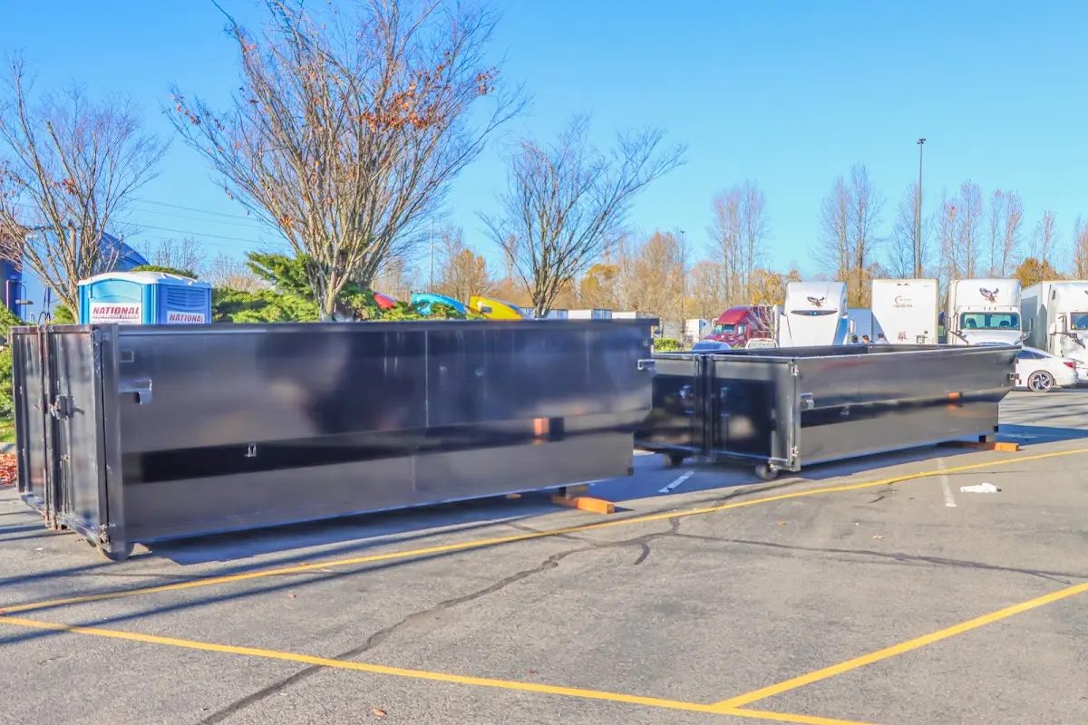 Professional dumpster rental service with roll-off container on residential driveway in Addison